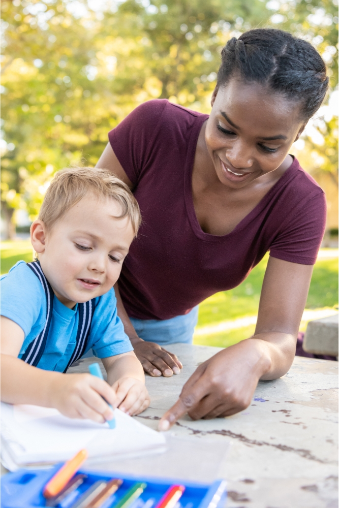 Preschool teacher helping a child