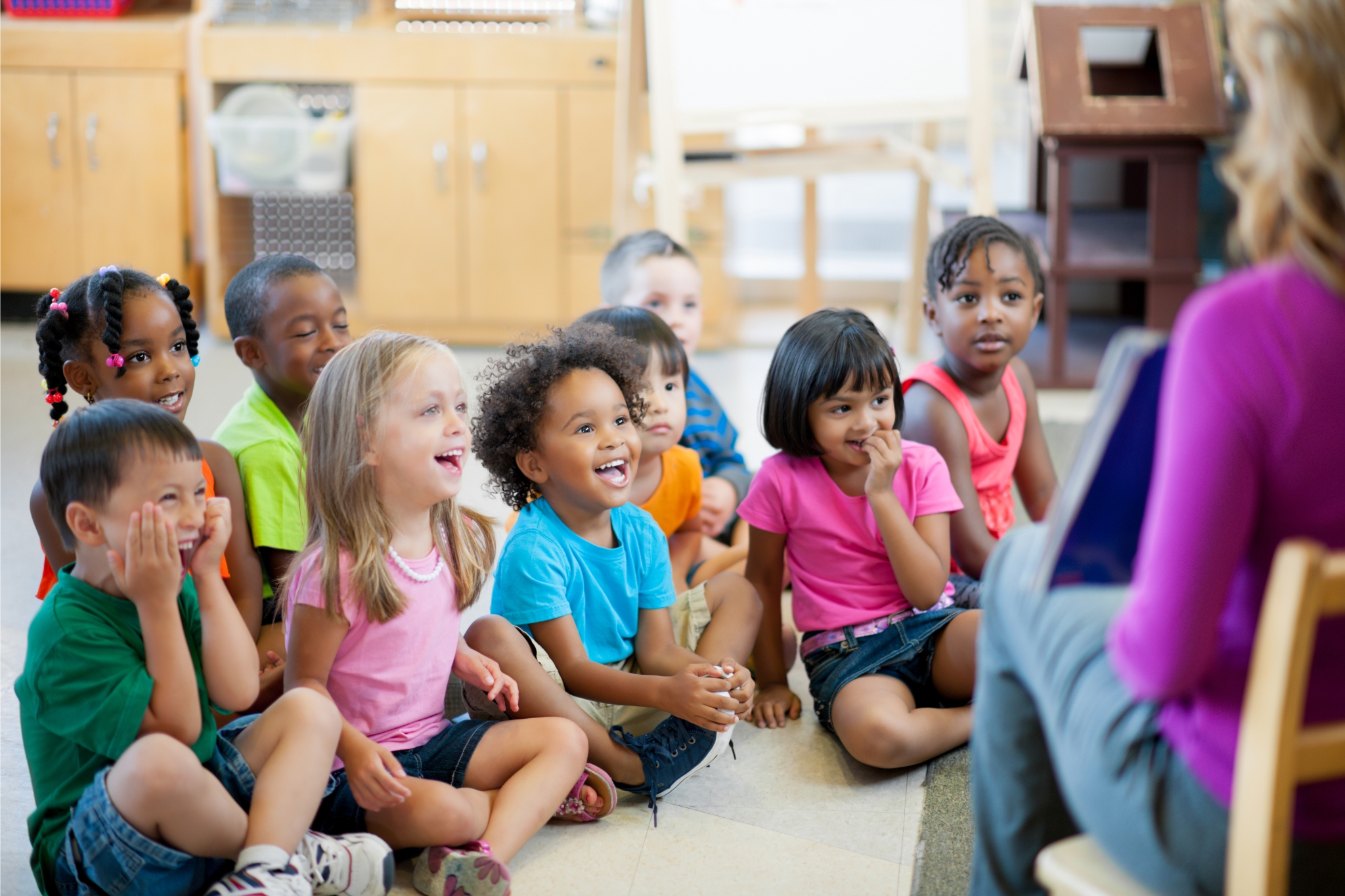 Kids listening to daycare director at River City Preschool